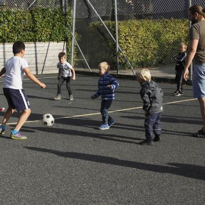 Forældre og børn spiller fodbold